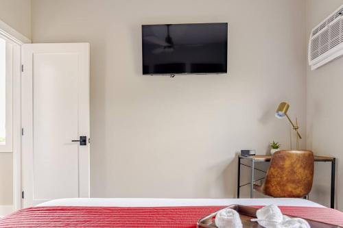 a bedroom with a bed and a tv on the wall at Altmar's Premier Luxury Cabin with 3000sf Mini Golf in Altmar