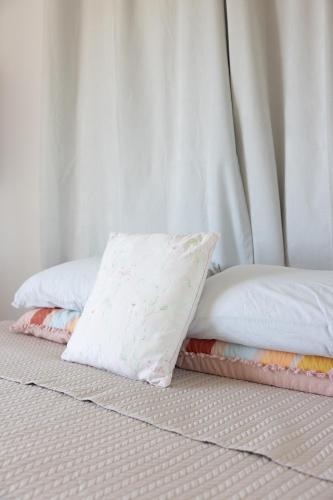 a bed with two pillows on top of it at Zen Escape Guest House " Location 2" - Zen Garden Tiny Home, Nooky Studio, Chillax Rest in Brisbane