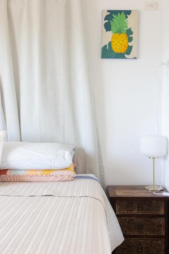a bedroom with a bed with a pineapple picture on the wall at Zen Escape Guest House " Location 2" - Zen Garden Tiny Home, Nooky Studio, Chillax Rest in Brisbane
