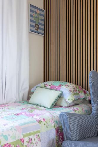 a bed with a pillow and a chair in a room at Zen Escape Guest House " Location 2" - Zen Garden Tiny Home, Nooky Studio, Chillax Rest in Brisbane