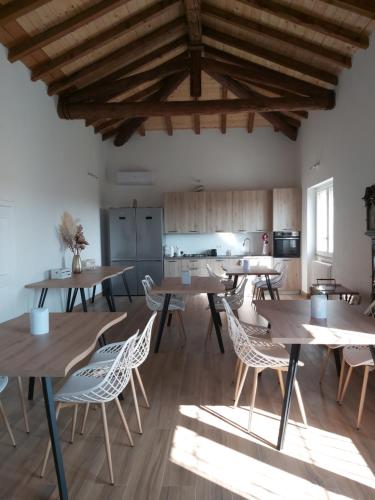a dining room with wooden tables and chairs at Cascina Olmetto di Sotto in Ghedi