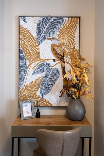 a picture of a table with a vase with a plant at Zen Luxury Apartments in Xanthi