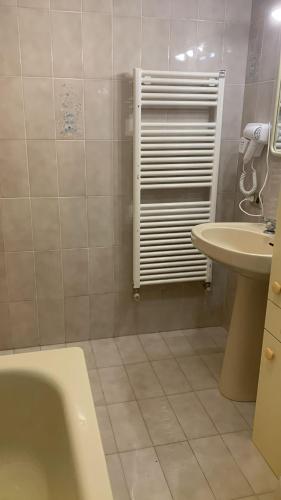 a bathroom with a bath tub and a sink at valle del paradiso 9 in Seggiano