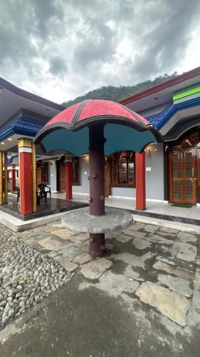 a building with a bench in front of it at Khushi homestay in Sari