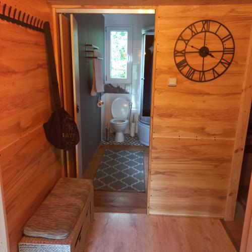 a bathroom with a toilet and a wooden door at Jeziorskie Zacisze 