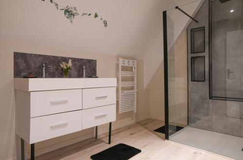 a bathroom with a white dresser and a shower at Le Petit Refuge in Saint-Béron