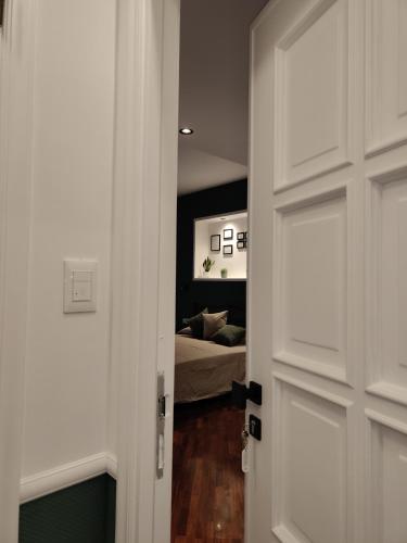 a door leading into a bedroom with a bed at Quintadecima Rooms in Palermo