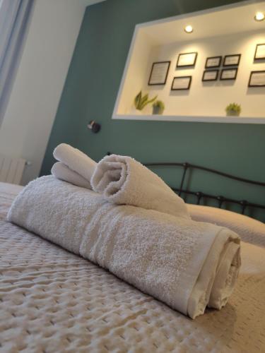 a pile of towels sitting on top of a bed at Quintadecima Rooms in Palermo