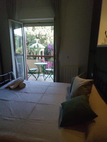 a bedroom with a bed with a view of a patio at Quintadecima Rooms in Palermo