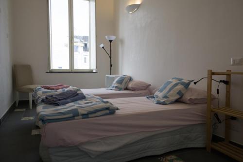 two twin beds in a room with a window at Attico San Mattia in Naples
