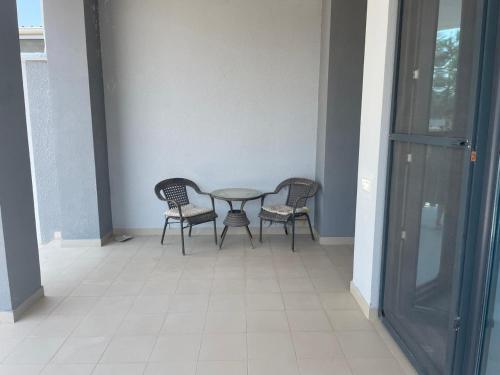 a table and four chairs in a hallway with a table and chairs at Вилла,Дача на берегу моря in Baku