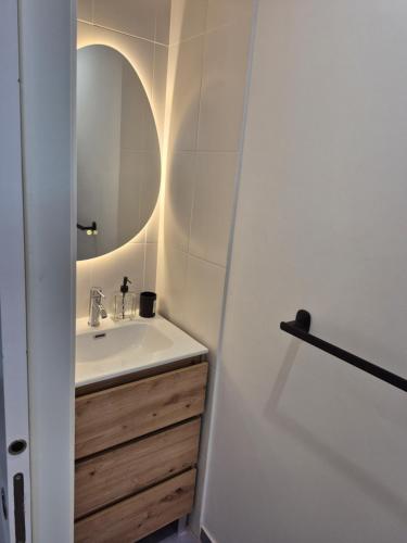 a bathroom with a sink and a mirror at Apartamento O Trebello in A Coruña