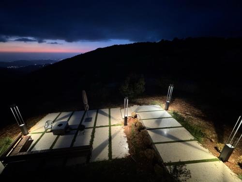a row of shadows on a sidewalk at night at AlFahed Farm in Ajloun
