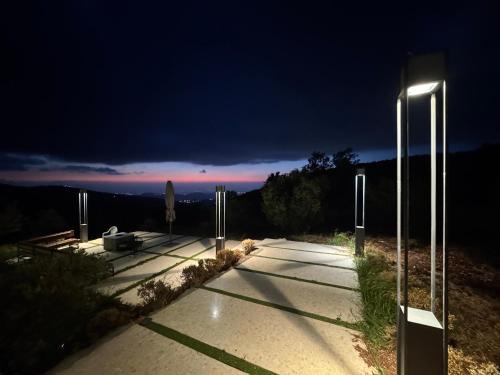 a street light on a sidewalk at night at AlFahed Farm in Ajloun
