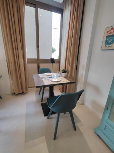 a dining room with a table and a chair at Quintadecima Rooms in Palermo