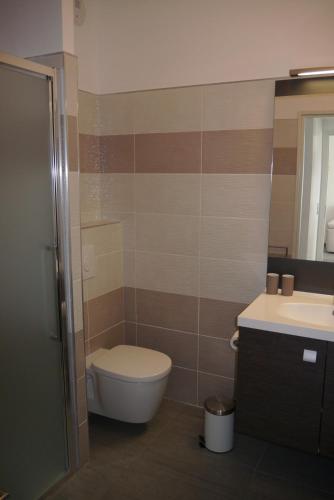 une salle de bain avec toilettes, lavabo et miroir dans l'établissement Very nice apartment 100 meters Calvi beach, à Calvi