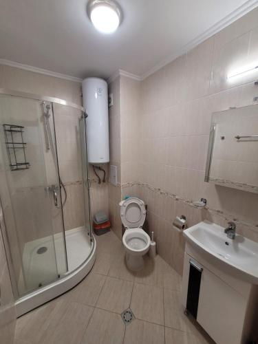 a bathroom with a shower and a toilet and a sink at Famagusta Antoniya in Aheloy