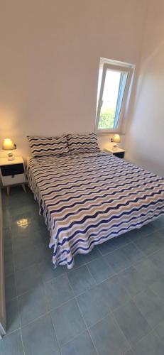 a large bed in a room with a window at La casa sotto le stelle - Ustica in Ustica