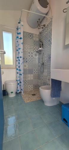 a bathroom with a shower and a tub and a toilet at La casa sotto le stelle - Ustica in Ustica