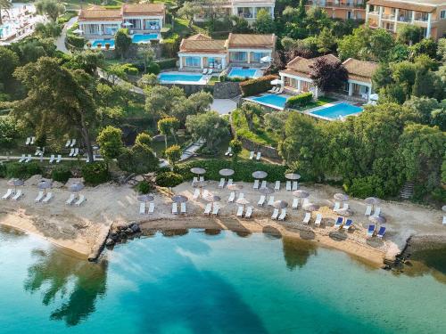 an aerial view of a resort with chairs and umbrellas at Grecotel Eva Palace in Kommeno