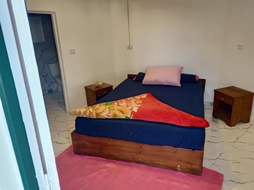 a bedroom with a bed and two night stands at فندق جرين فالي دهب - Green Valley Hotel in Dahab