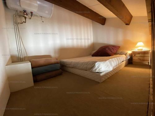 a small bedroom with a bed and a night stand at Charmant studio cabine mezzanine pour 4 personnes, proche centre, casier à skis - FR-1-295-130 in Les Angles
