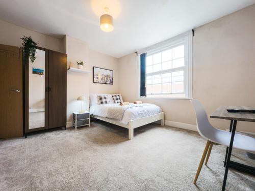 un dormitorio con una cama y una ventana en Casa Botique - Comfort Stay, Free Parking, en Portsmouth