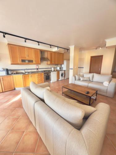 a large living room with a couch and a table at Casa De Sousa-Refúgio de Surf entre Peniche e Ericeira in A dos Cunhados