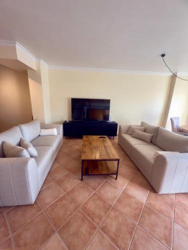 a living room with two couches and a coffee table at Casa De Sousa-Refúgio de Surf entre Peniche e Ericeira in A dos Cunhados