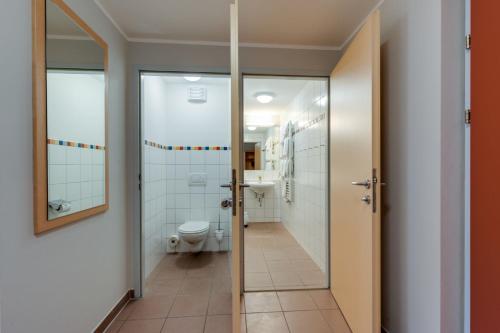 a bathroom with a toilet and a sink at JUFA Hotel Veitsch in Veitsch
