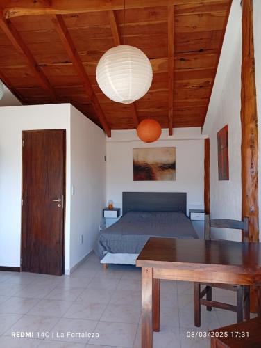 a bedroom with a bed and a wooden ceiling at La Fortaleza Deptos in Villa Traful