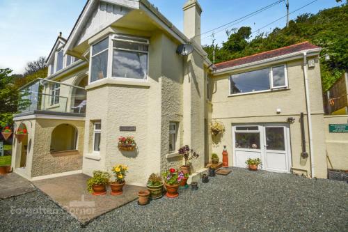 a house with potted plants in front of it at Finest Retreats - Upper Deck in Cawsand