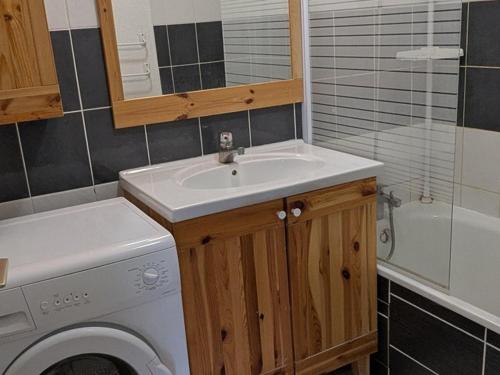 une salle de bain avec un lavabo et une machine à laver dans l'établissement Appartement lumineux 3 pièces 8 pers, proche des pistes avec cuisine équipée - FR-1-262-73, à Forest des Baniols
