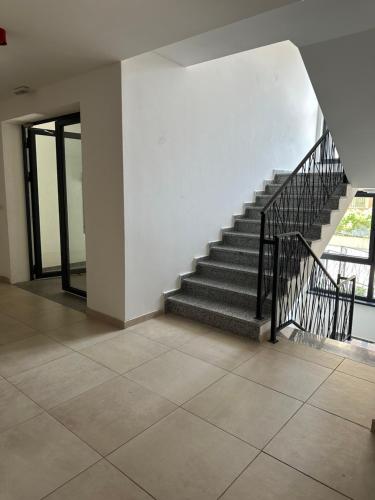 a staircase in a building with a tile floor at ZORA apartmani Sarajevo in Sarajevo