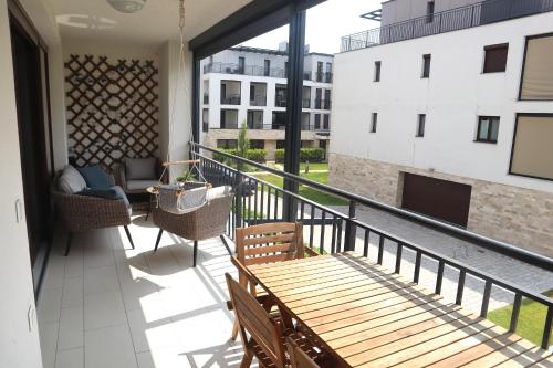a balcony with a table and chairs and a fireplace at Fehér Lótusz Csopak in Csopak