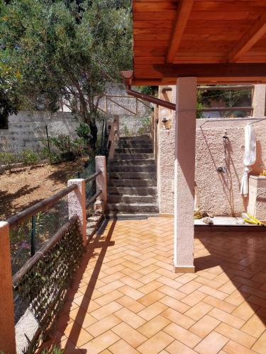 a wooden patio with stairs and a wooden roof at Casa LeMa in Geremèas