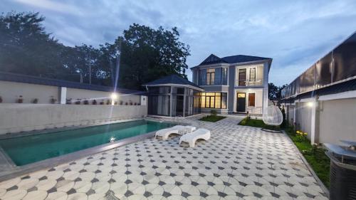 a house with a swimming pool in front of a house at Gabala Breeze Villa in Gabala