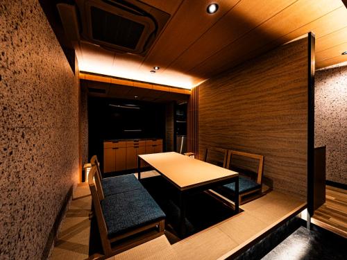 a small dining room with a table and chairs at 十二ホテル -福岡空港- in Fukuoka
