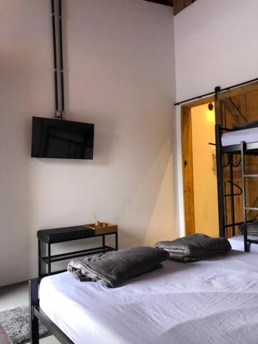 a bedroom with a bed with two pillows on it at Espaço Vila do Vale in São Roque