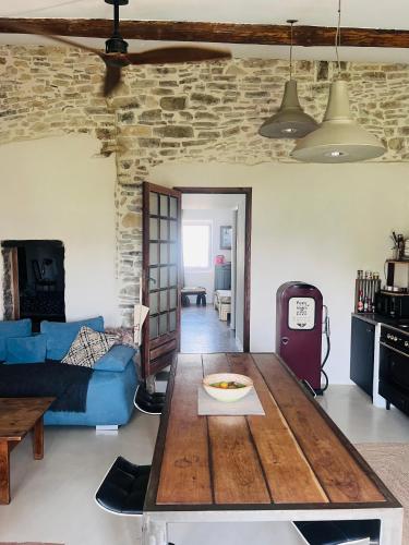un salon avec un canapé bleu et une table dans l'établissement L'Ostal des Embruscalles, à Claret
