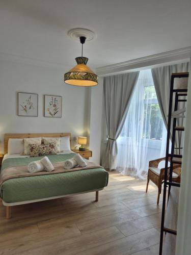 a bedroom with a bed and a large window at Apartamento O Trebello in A Coruña