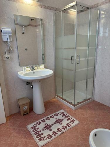 a bathroom with a sink and a glass shower at Borgo Rosalia in Galatina