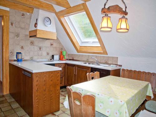 a kitchen with a table and a sink and a window at Vogtadeshof in Wolfach