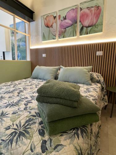 a bedroom with a bed with pillows on it at Tati's Home CHARME in Mandello del Lario