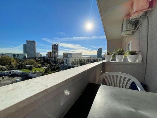 a balcony with a table and a chair on a building at Kadare City-Center Apartment with Balcony in Tirana