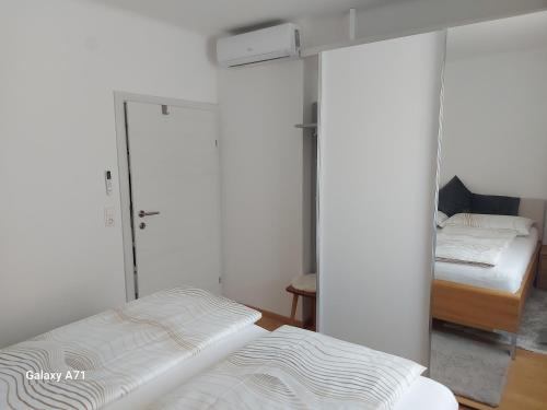 a bedroom with two beds and a mirrored wall at Ferienhaus Käthe in Klagenfurt