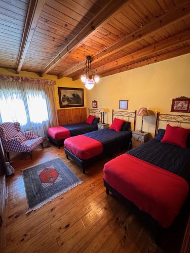 a bedroom with two beds and a couch and a chair at Finca La Pedrera in Capellades