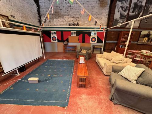 a living room with a white screen and a couch at Finca La Pedrera in Capellades