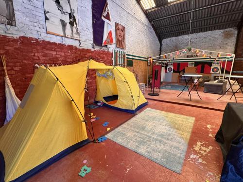 a room with a tent and a stage at Finca La Pedrera in Capellades