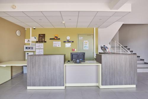 a hospital lobby with a desk with a computer on it at Résidence Odalys Côté Canal in Sallèles-dʼAude
